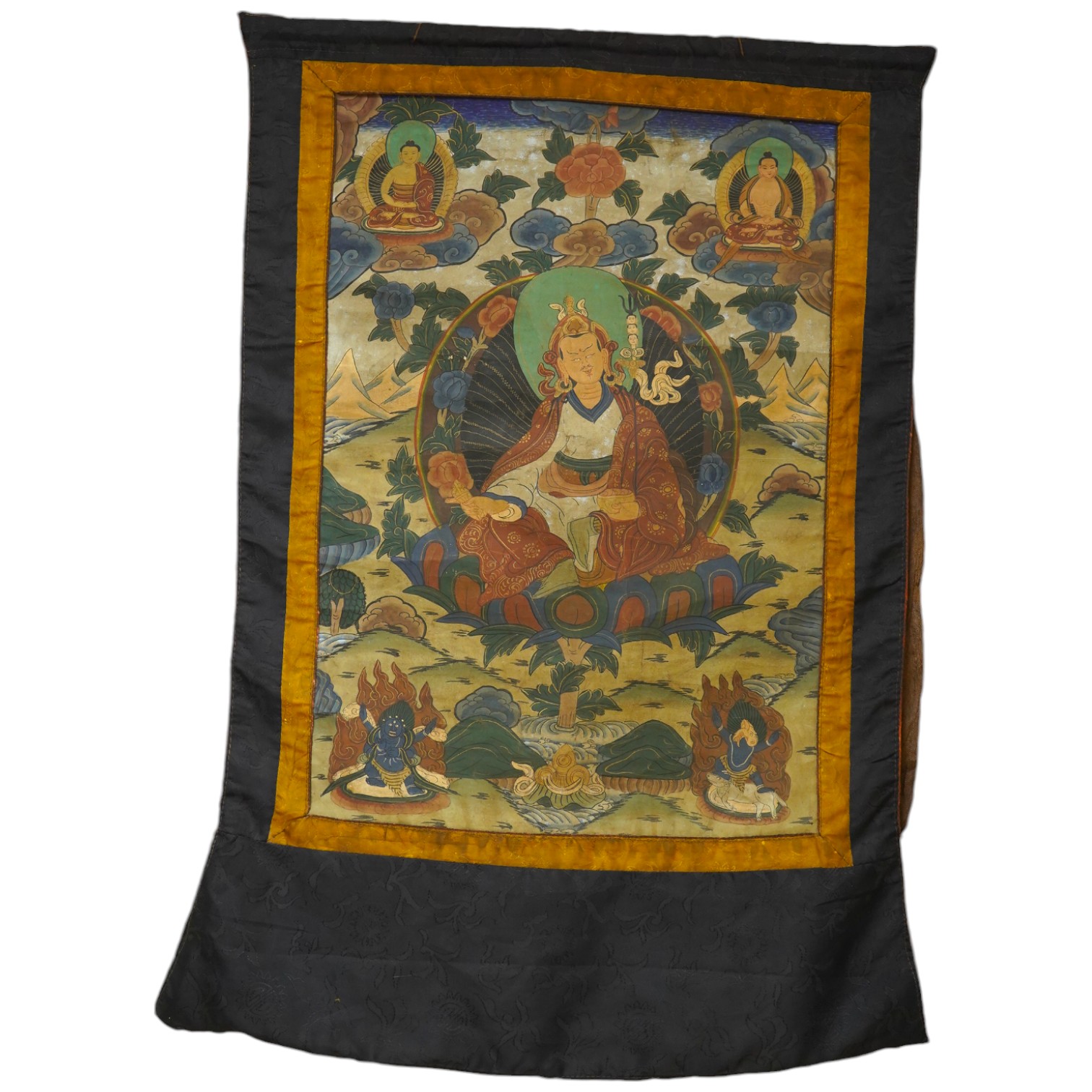 A Tibetan painted silk thangka, depicting Padmadambhara seated on a throne of lotus petals, 19th century